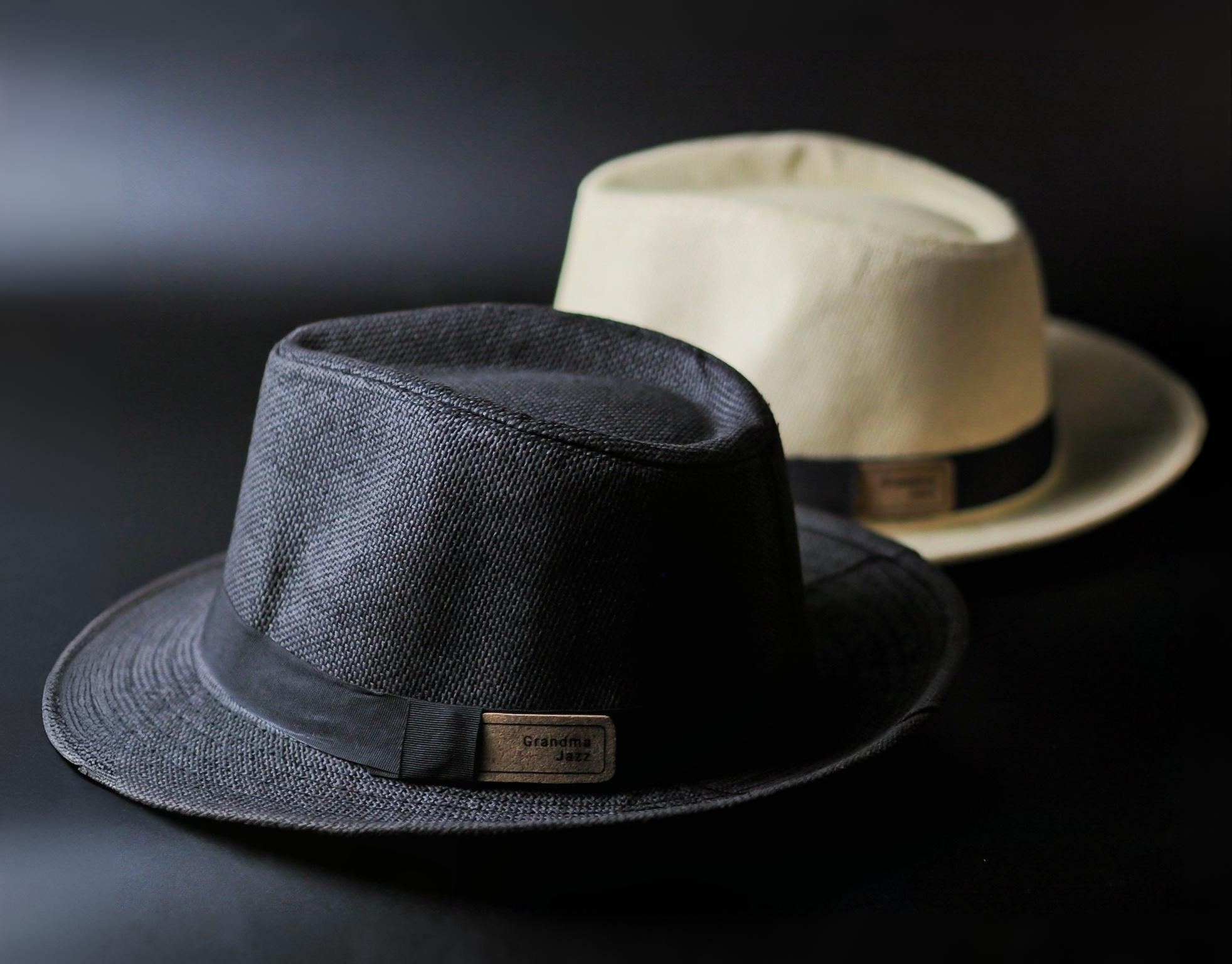 Collection of artisanal spirits featuring Thai-inspired botanicals in elegant glass bottles, displayed on wooden shelves with soft backlighting